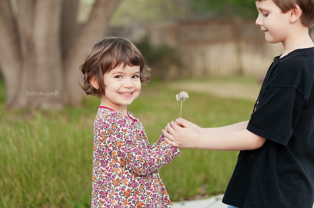 Austin lifestyle child photographer dandelion puff friendship happiness